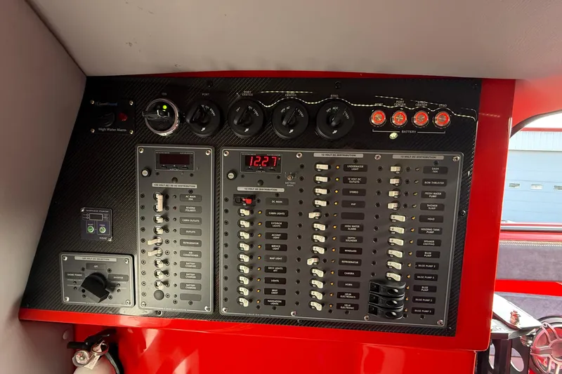 Slide: The Image of Control panel of a 2020 MTI 42V boat with switches and gauges. - 17