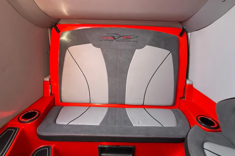 Slide: The Image of Red and gray seating in 2020 MTI 42V boat interior, featuring cup holders. - 18