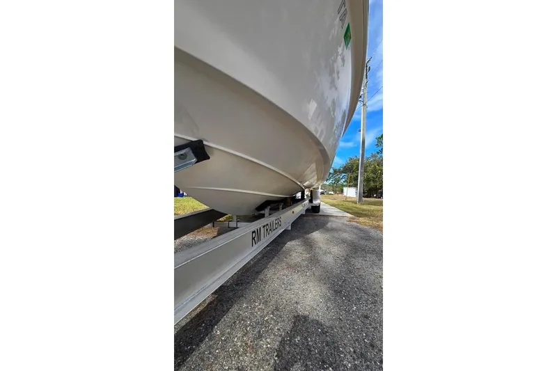 Slide: The Image of 2014 Everglades 295 Pilot boat on RM trailer, parked outdoors. - 12