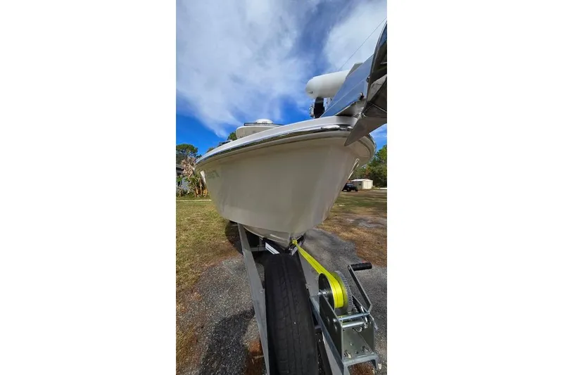 Slide: The Image of 2014 Everglades 295 Pilot boat on trailer, viewed from below, against a blue sky. - 13