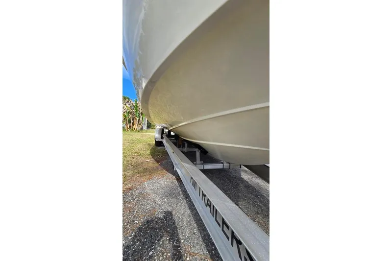 Slide: The Image of 2014 Everglades 295 Pilot boat on trailer, side view, outdoors. - 15