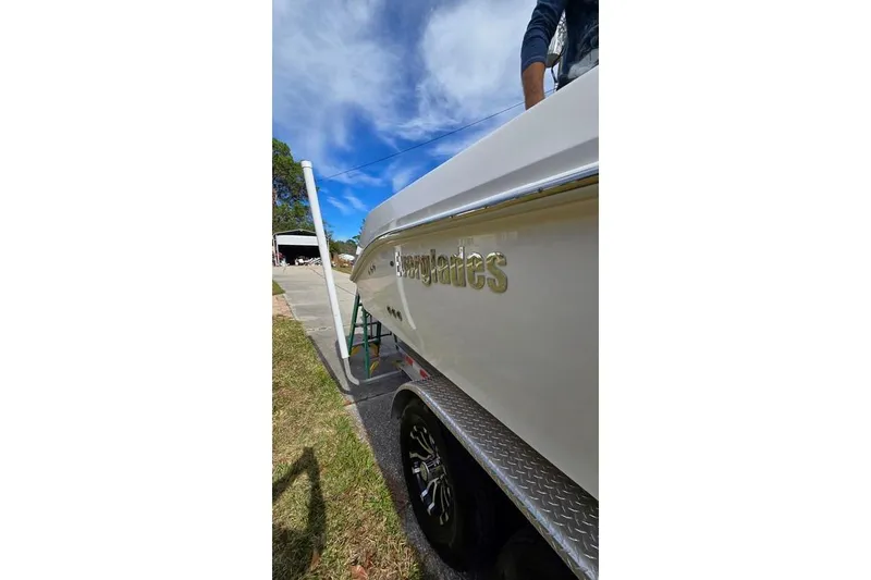 Slide: The Image of 2014 Everglades 295 Pilot boat on trailer under blue sky. - 17