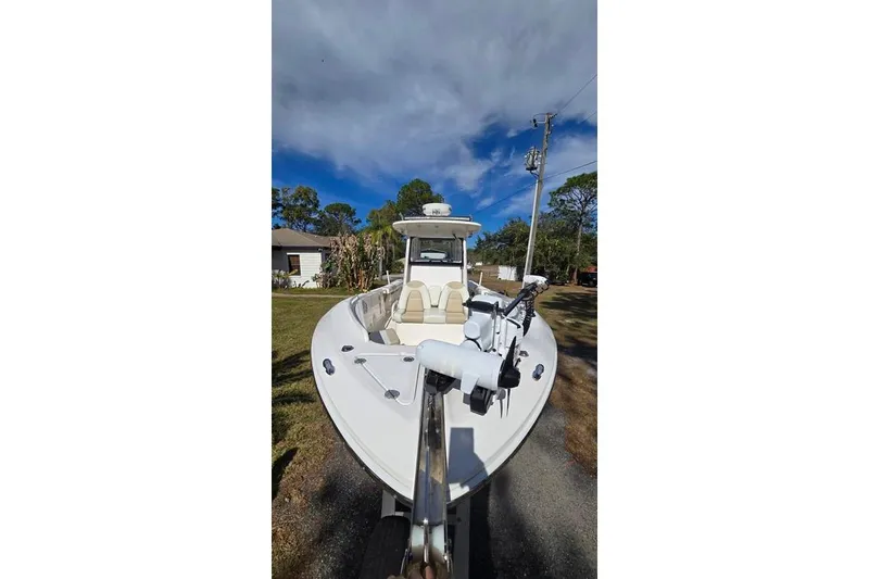 Slide: The Image of 2014 Everglades 295 Pilot boat parked on a driveway under a cloudy sky. - 18
