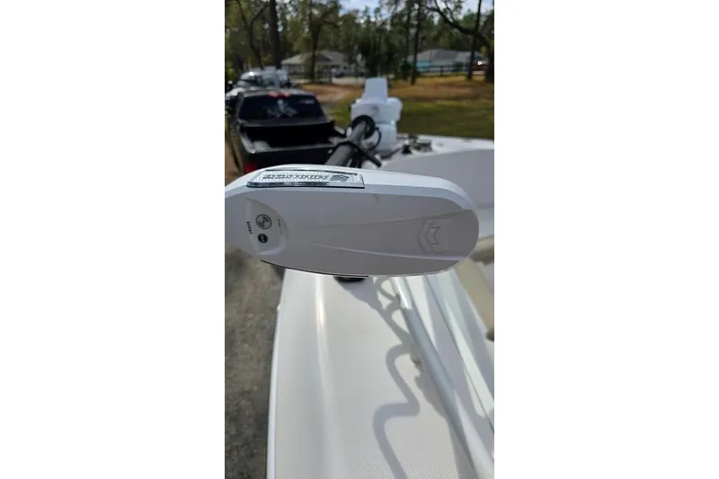 Slide: The Image of 2014 Everglades 295 Pilot boat with trolling motor, parked outdoors. - 20