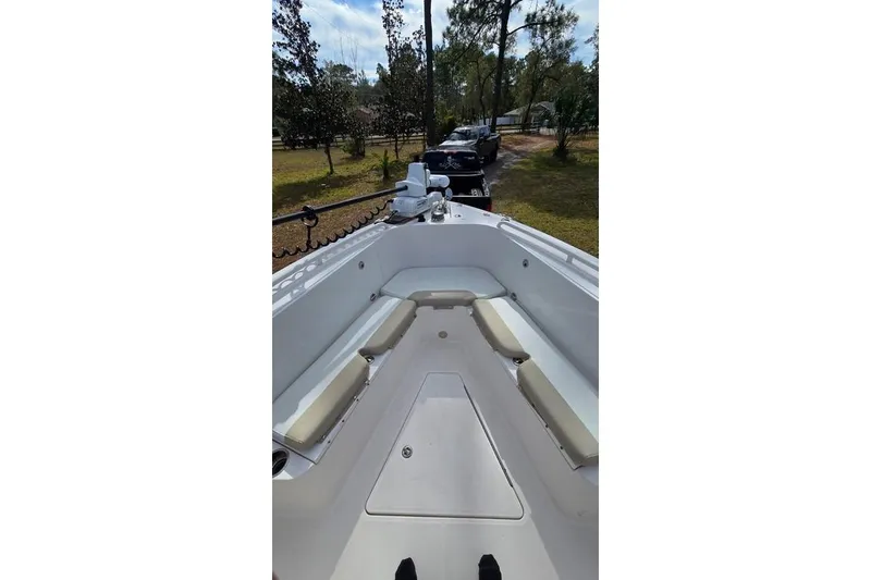Slide: The Image of 2014 Everglades 295 Pilot boat interior with seating, parked outdoors. - 22