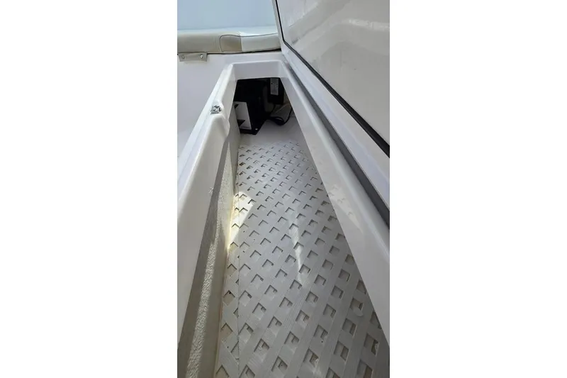 Slide: The Image of 2014 Everglades 295 Pilot boat interior with textured flooring and seating. - 26