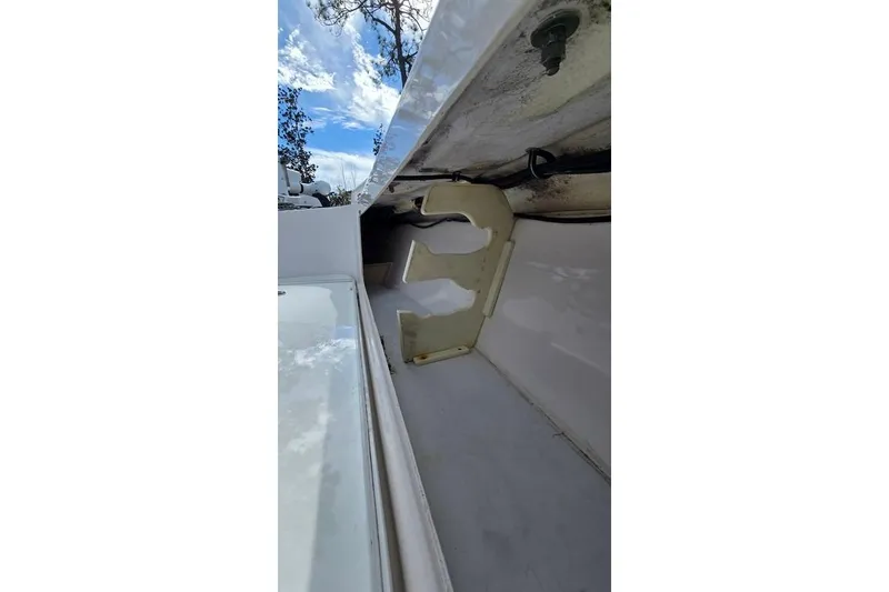 Slide: The Image of 2014 Everglades 295 Pilot boat interior storage compartment with open hatch. - 27