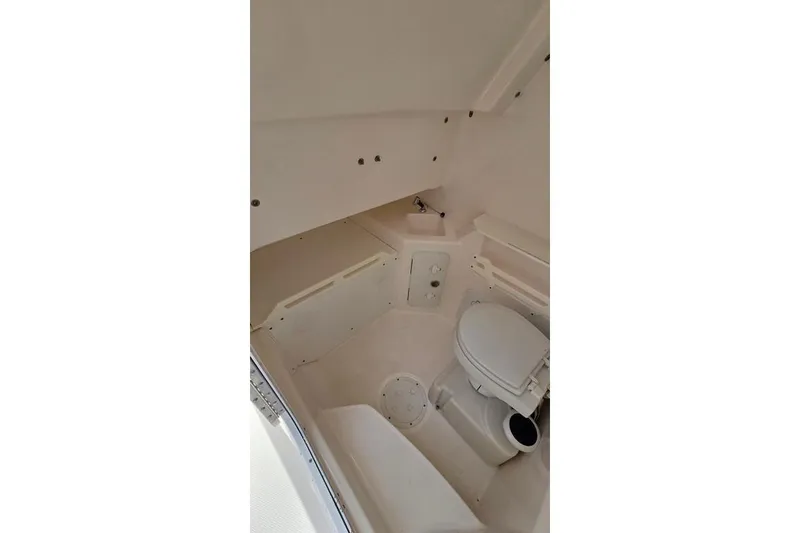 Slide: The Image of Interior of 2014 Everglades 295 Pilot boat featuring a compact marine toilet. - 29