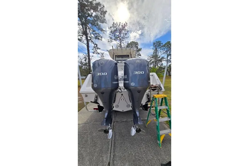 Slide: The Image of 2014 Everglades 295 Pilot boat with twin Yamaha 300 engines, parked outdoors. - 3