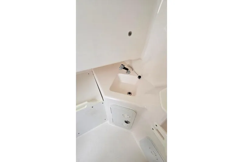 Slide: The Image of 2014 Everglades 295 Pilot boat interior with sink and storage compartments. - 32