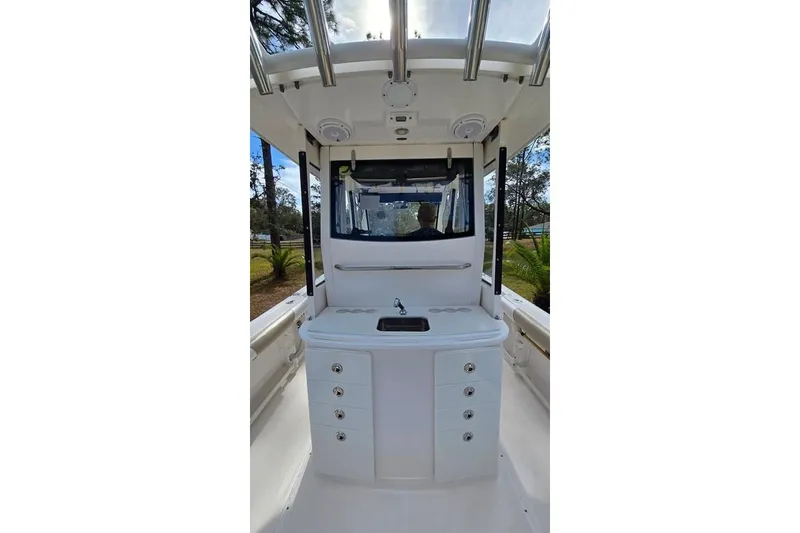 Slide: The Image of 2014 Everglades 295 Pilot boat interior with sink and storage drawers. - 34