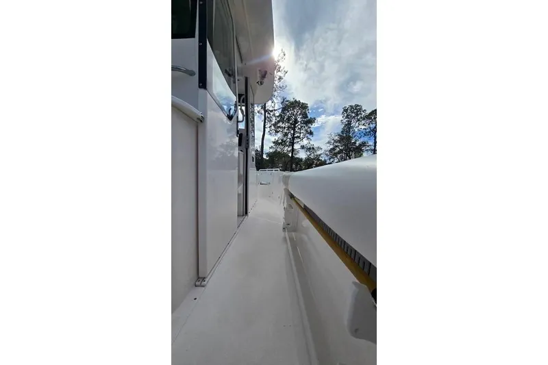 Slide: The Image of Side view of 2014 Everglades 295 Pilot boat under a cloudy sky. - 46