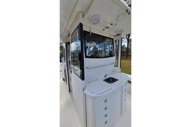 Slide: The Image of 2014 Everglades 295 Pilot boat interior with sink and storage cabinets. - 48