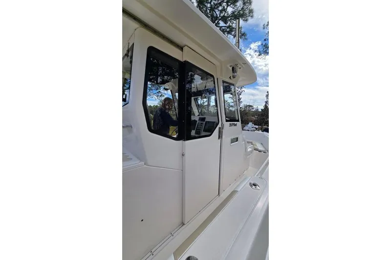 Slide: The Image of 2014 Everglades 295 Pilot boat, side view with cabin and windows. - 50