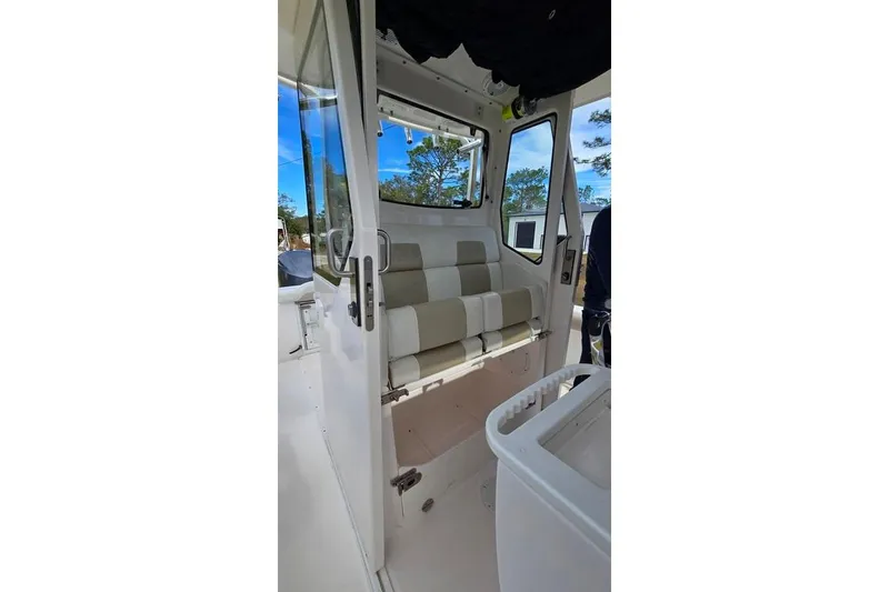 Slide: The Image of Interior view of 2014 Everglades 295 Pilot boat with cushioned seating. - 51