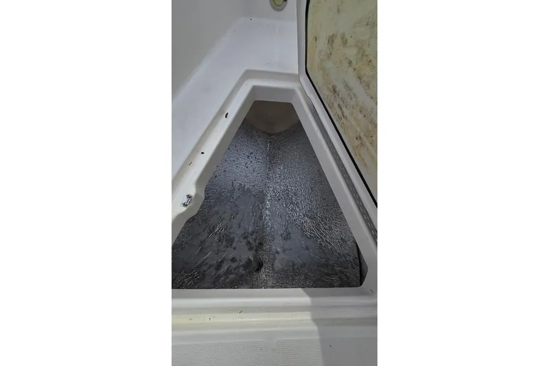 Slide: The Image of Interior view of 2014 Everglades 295 Pilot boat compartment, showing storage space. - 54