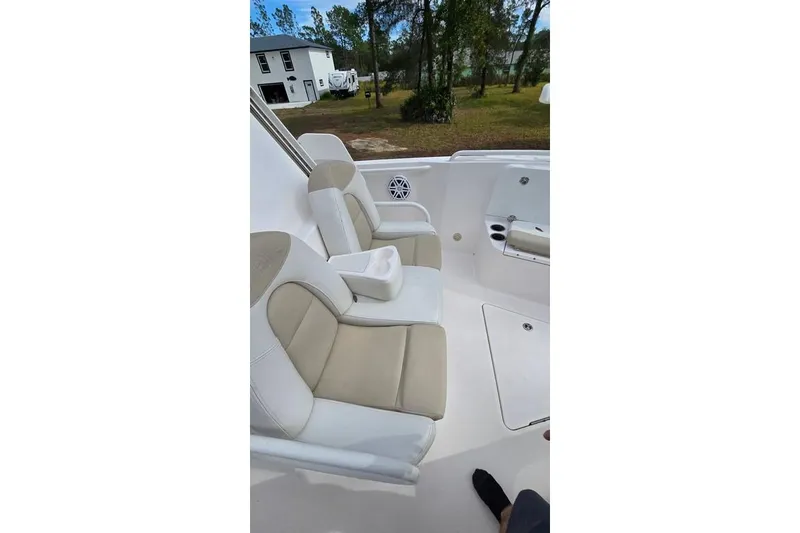 Slide: The Image of 2014 Everglades 295 Pilot boat interior with beige and white seating. - 55