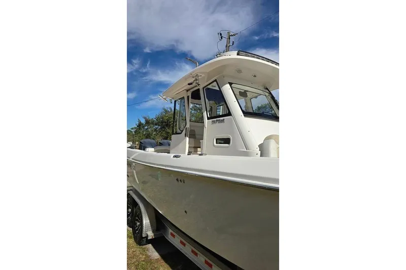 Slide: The Image of 2014 Everglades 295 Pilot boat on trailer under clear blue sky. - 6