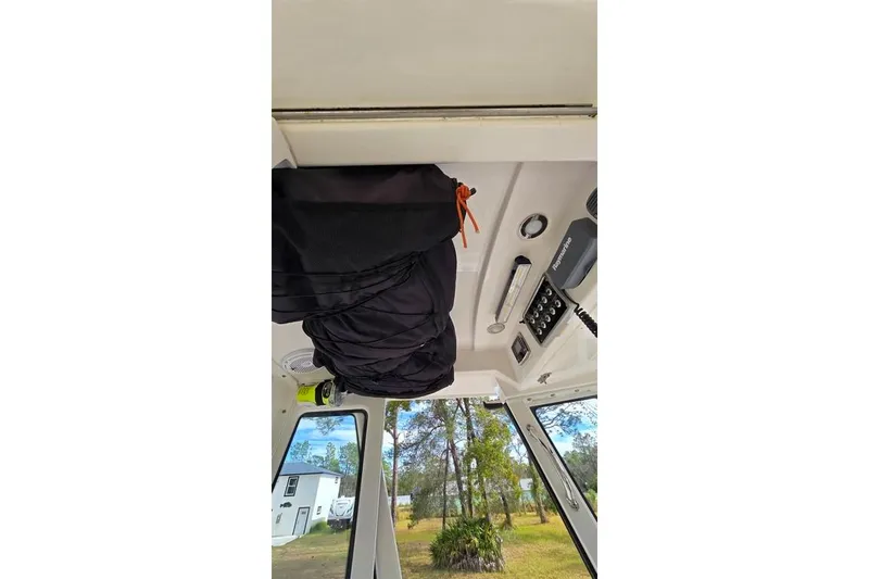 Slide: The Image of Interior view of 2014 Everglades 295 Pilot boat with equipment and windows. - 63