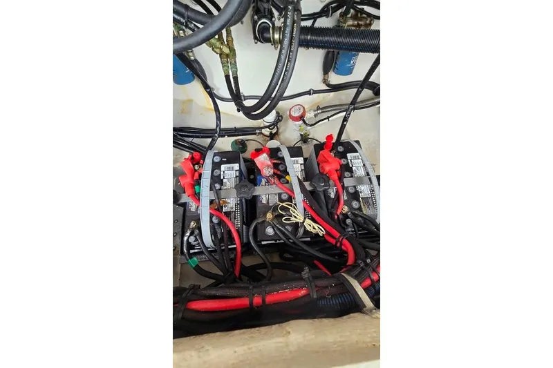 Slide: The Image of Battery compartment of 2014 Everglades 295 Pilot boat with wiring and connections. - 66