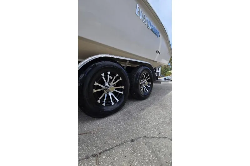 Slide: The Image of Trailer wheels of a 2014 Everglades 295 Pilot boat on pavement. - 71