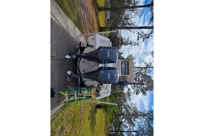Slide: The Image of 2014 Everglades 295 Pilot boat with dual outboard engines on a driveway. - 73