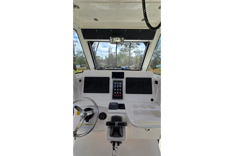 Slide: The Image of Interior view of 2014 Everglades 295 Pilot boat cockpit with steering wheel and control panel. - 74