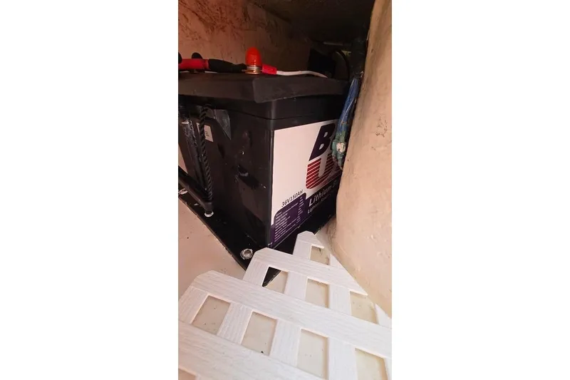 Slide: The Image of Battery compartment of 2014 Everglades 295 Pilot boat, featuring a lithium battery. - 76