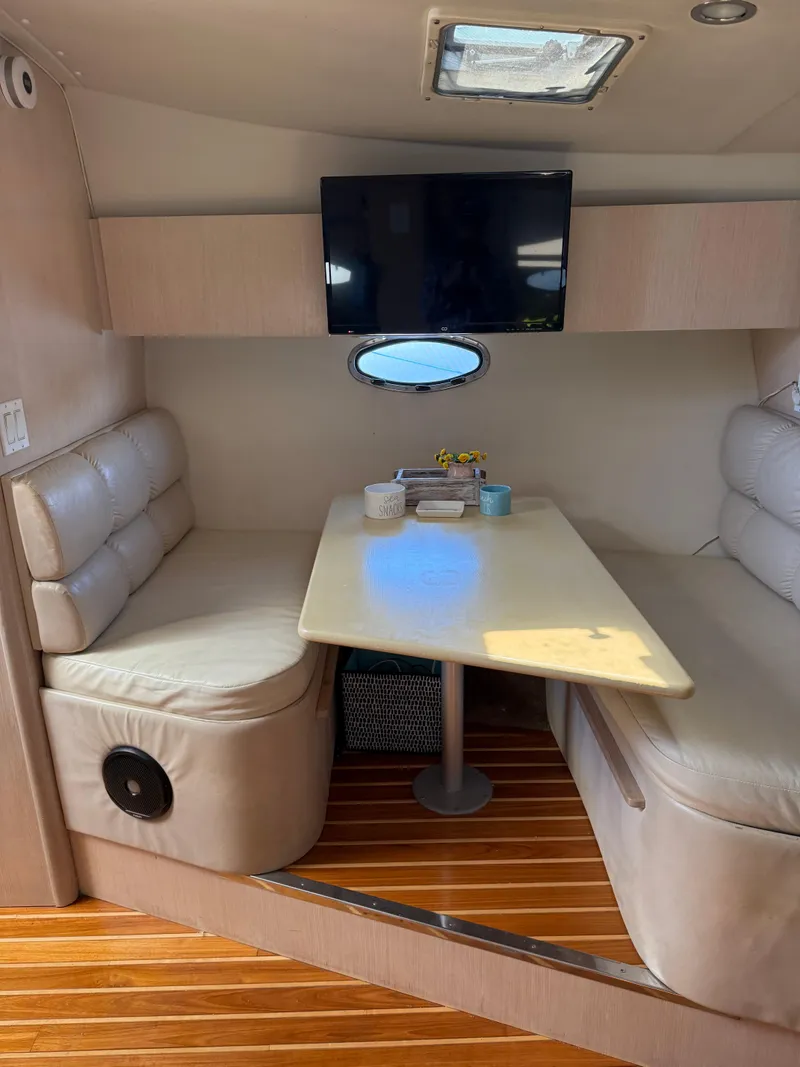 Slide: The Image of 1996 Tiara Yachts 3500 Express interior with table and seating area. - 16