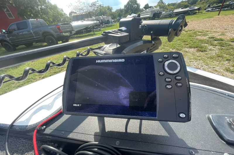 Slide: The Image of Humminbird Helix 7 fish finder on Nitro Z17 boat, parked near trucks and trailers. - 6