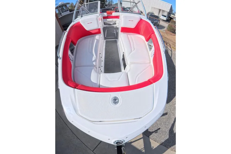 Slide: The Image of 2009 Sea-Doo Sport Boats 230 Wake with red and white seating, docked outdoors. - 13