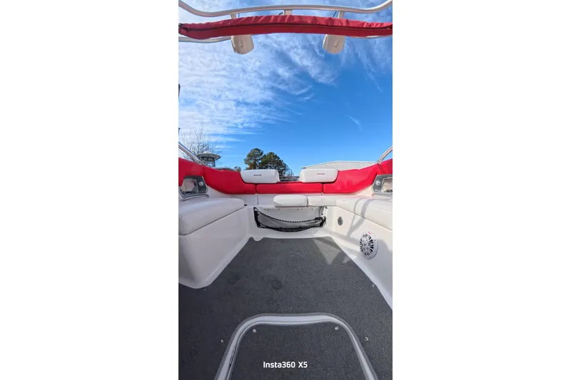 Slide: The Image of 2009 Sea-Doo 230 Wake boat interior with red seating and clear blue sky. - 18