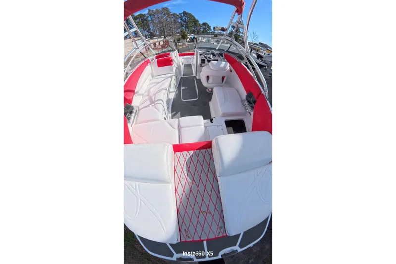 Slide: The Image of 2009 Sea-Doo Sport Boats 230 Wake covered in storage, indoor warehouse setting. - 8