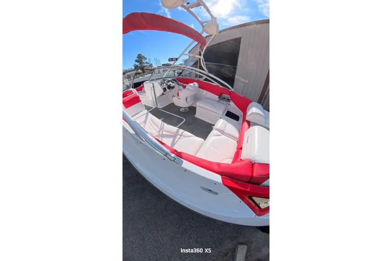 Slide: The Image of Interior view of 2009 Sea-Doo 230 Wake boat with red seating. - 9