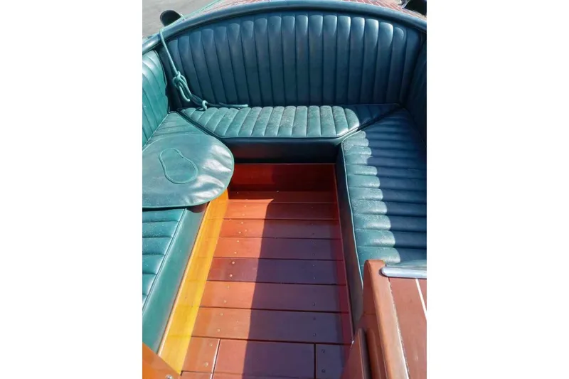 Slide: The Image of Interior of 1997 Hacker-Craft 26' Runabout with green leather seating and wooden flooring. - 10
