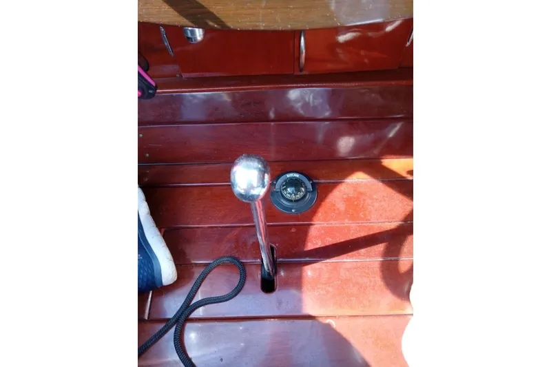 Slide: The Image of Interior of a 1997 Hacker-Craft 26' Runabout with wooden flooring and compass. - 11