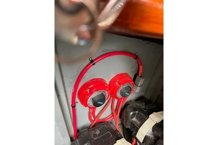 Slide: The Image of Red electrical wiring and switches inside a 1997 Hacker-Craft 26' Runabout boat. - 22