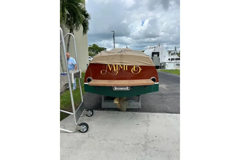 Slide: The Image of 1997 Hacker-Craft 26' Runabout boat with cover, parked on a trailer. - 24