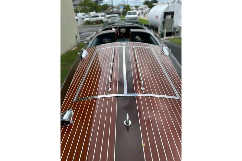 Slide: The Image of 1997 Hacker-Craft 26' Runabout with polished wooden deck and chrome accents. - 27