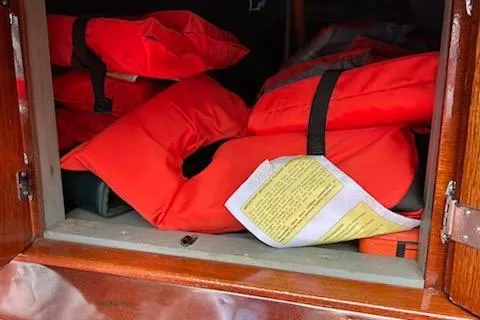 Slide: The Image of Red life jackets stored in a 1997 Hacker-Craft 26' Runabout boat compartment. - 30