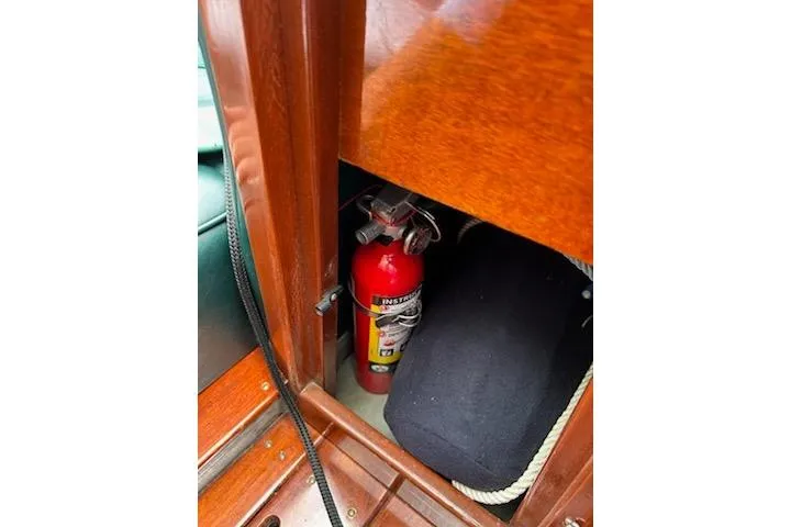 Slide: The Image of Fire extinguisher in 1997 Hacker-Craft 26' Runabout wooden interior compartment. - 31