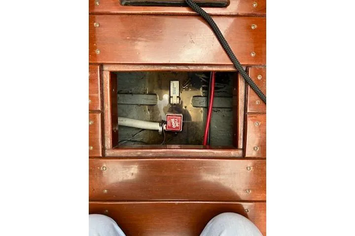 Slide: The Image of Interior view of a 1997 Hacker-Craft 26' Runabout, showcasing wooden paneling and wiring. - 32