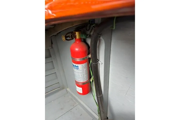 Slide: The Image of Fire extinguisher inside 1997 Hacker-Craft 26' Runabout boat interior. - 33