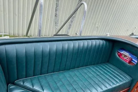 Slide: The Image of 1997 Hacker-Craft 26' Runabout with teal leather seating and wooden accents. - 35
