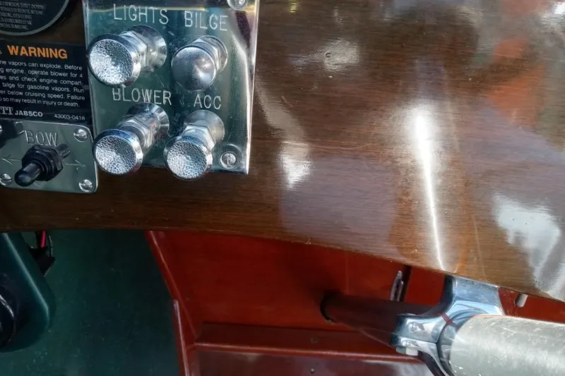 Slide: The Image of Control panel of a 1997 Hacker-Craft 26' Runabout with switches for lights, bilge, blower, and accessories. - 37