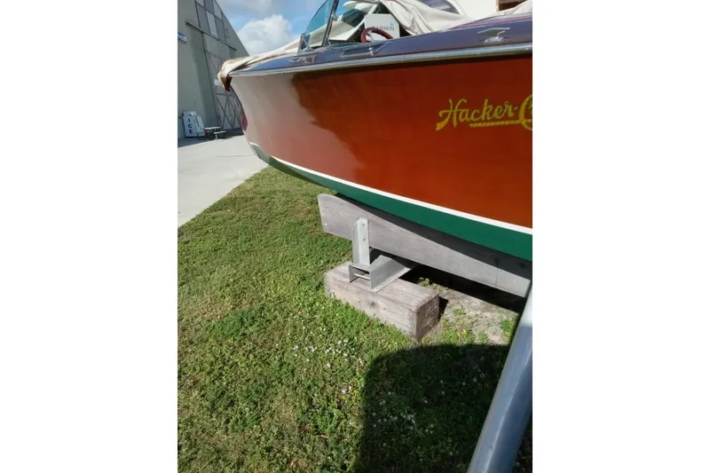 Slide: The Image of 1997 Hacker-Craft 26' Runabout boat on display, showcasing classic wooden design. - 43