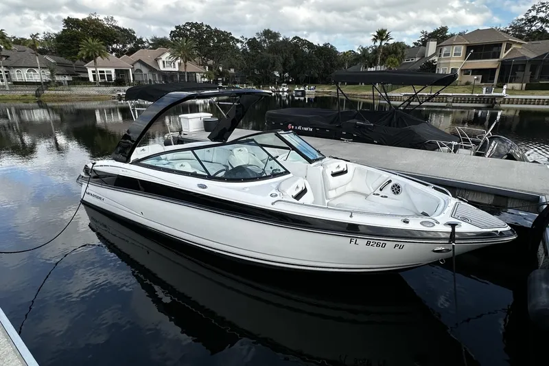 The Image of 2015 Monterey 264FS boat docked on a calm residential waterfront. - 0