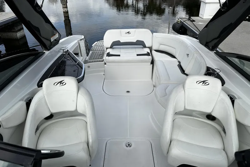 Slide: The Image of 2015 Monterey 264FS boat interior with white seating and open deck layout. - 11