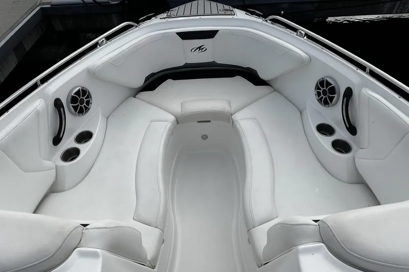 Slide: The Image of Luxurious 2015 Monterey 264FS boat interior with white seating and cup holders. - 15