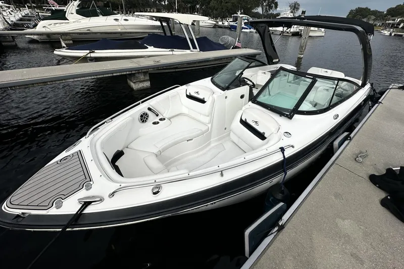 Slide: The Image of 2015 Monterey 264FS boat docked at marina, featuring sleek design and spacious seating. - 2